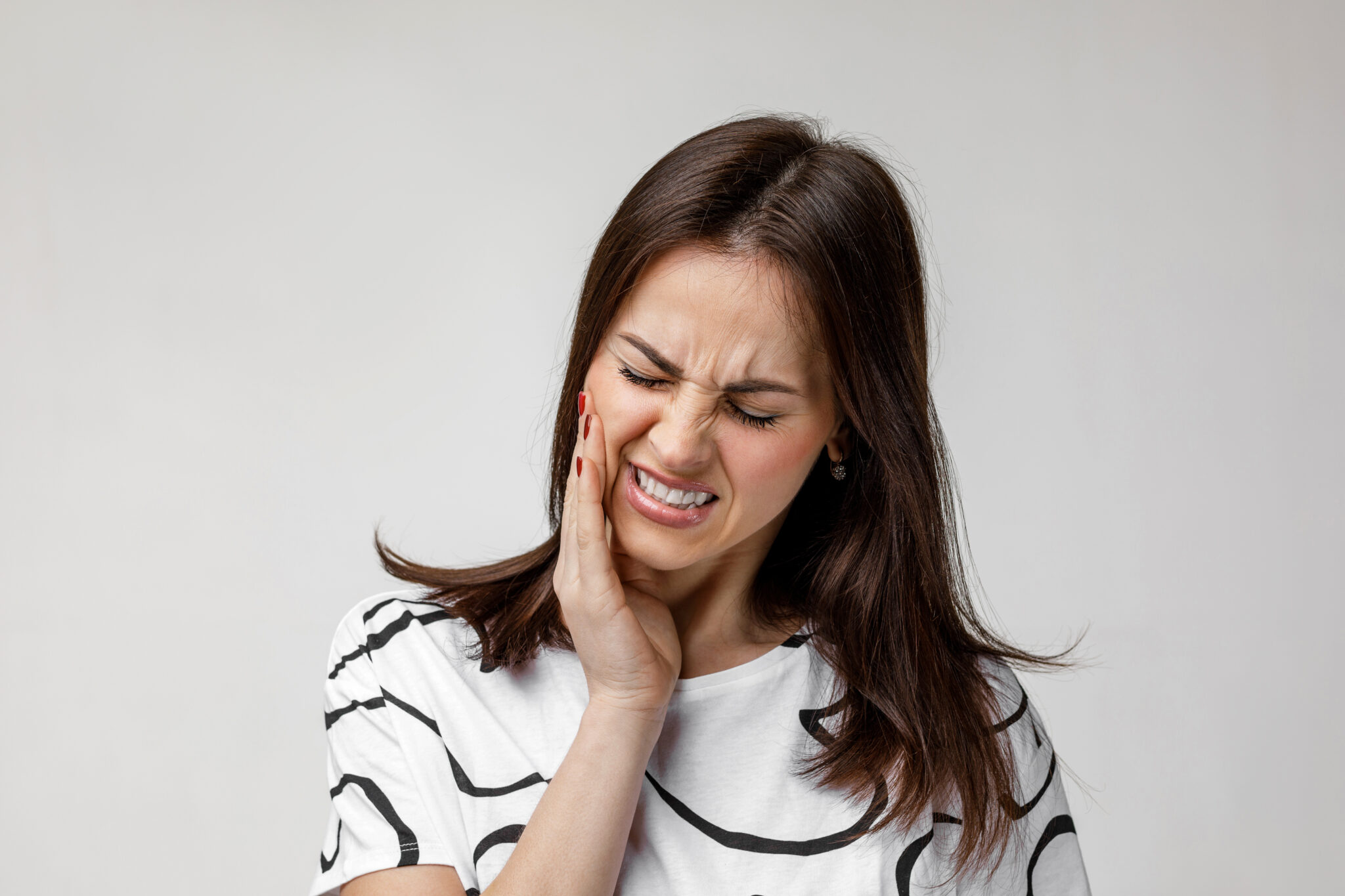 young sad woman suffering from tooth pain woman with sore tooth - Ideal Image Dentistry