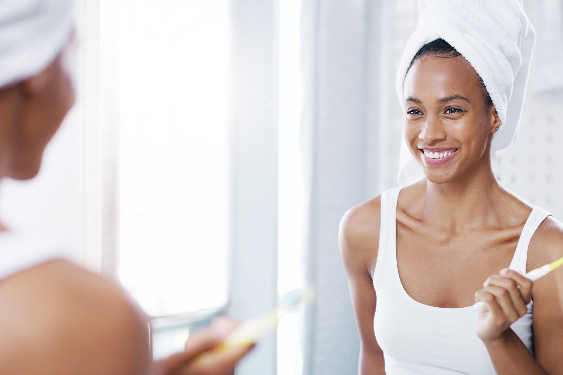 Keeping your gums healthy Smiling young woman - Ideal Image Dentistry