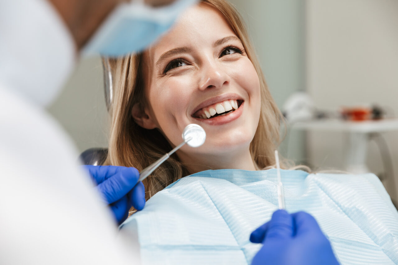 A woman getting a filling at a dentist appointment.